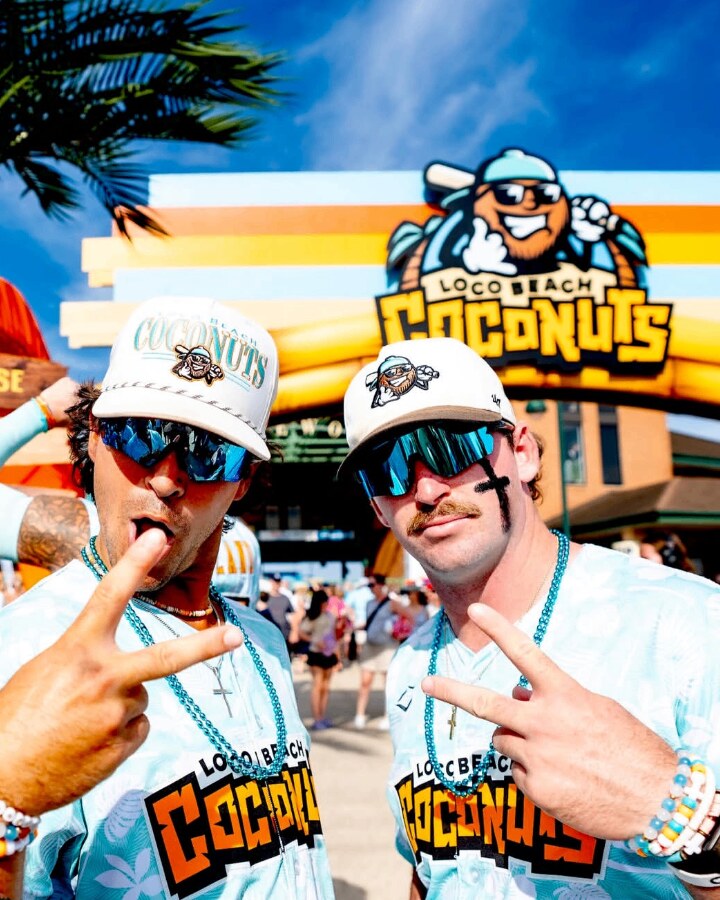 Two ballplayers reppin' Squintz on a sunny ballpark plaza