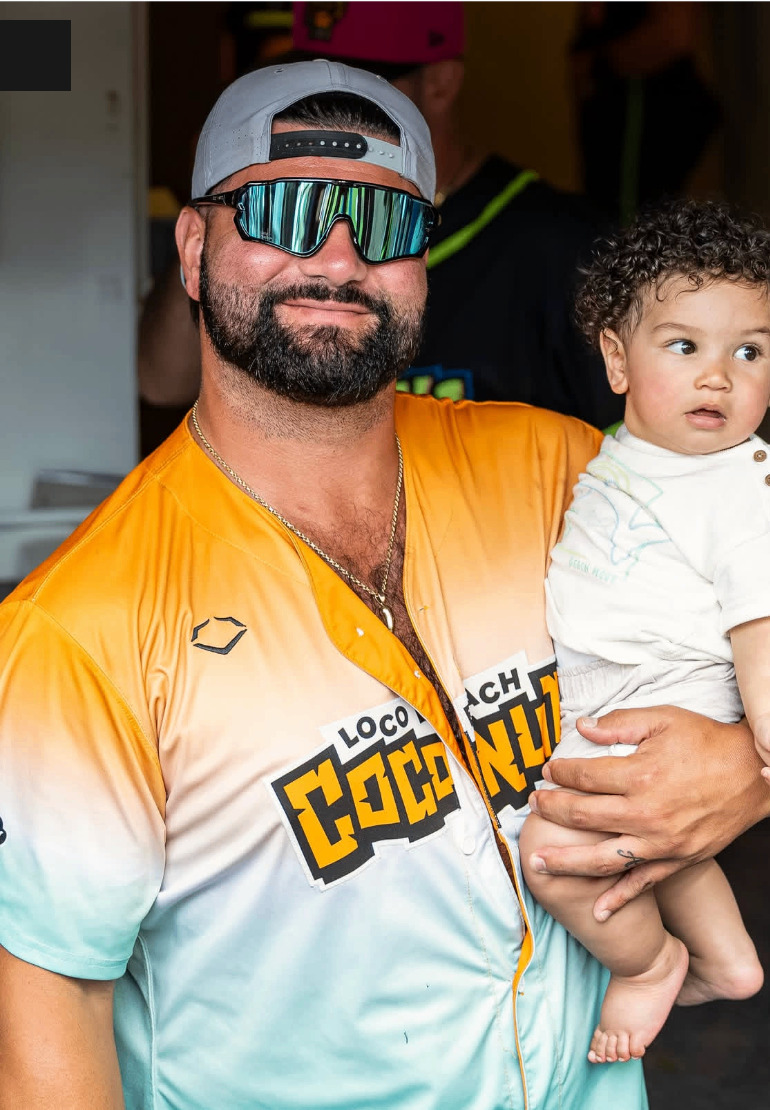 Dad in Squintz holding his son in the dugout tunnel
